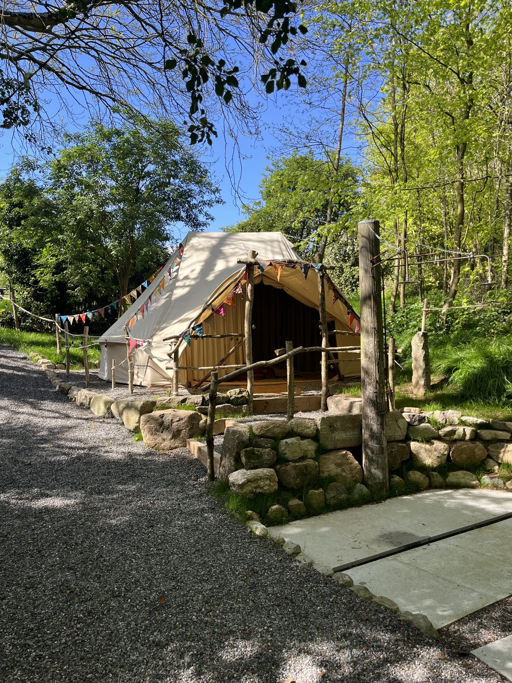 The changing yurt beside the gravel path, bunting strung across the entrance