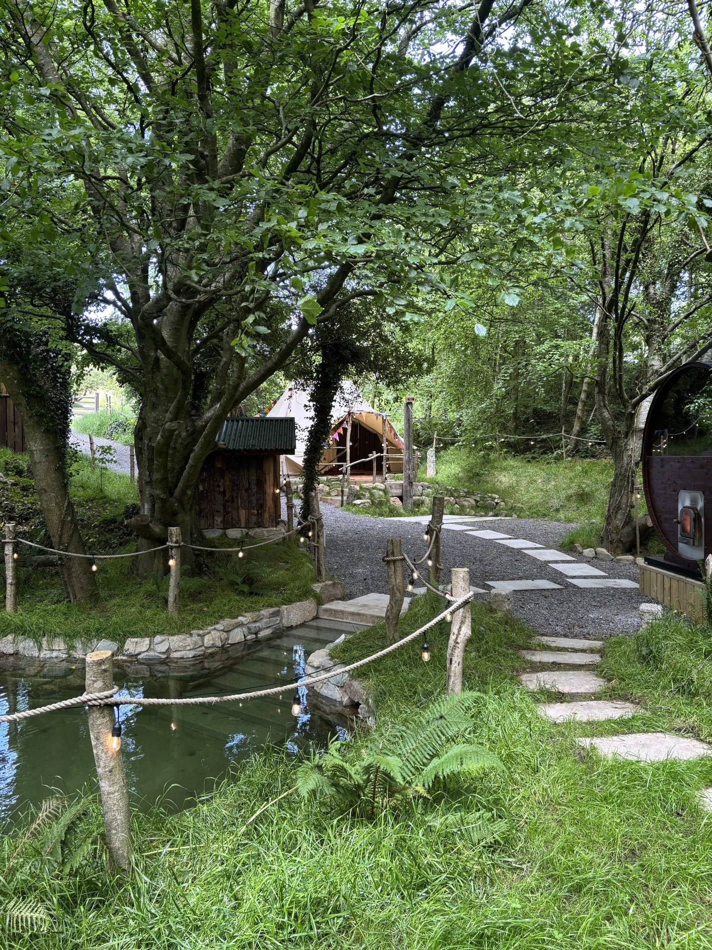 The path down past the spring-fed plunge towards the changing yurt and sauna at An Sruthán